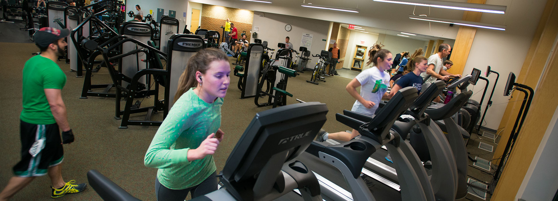 Students and community members run on treadmills in the S.H.A.P.E Facility