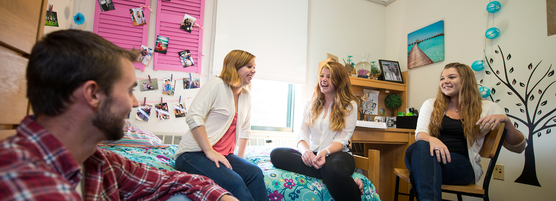 Students laugh and visit in one of the dormitories at the Randolph Center Campus