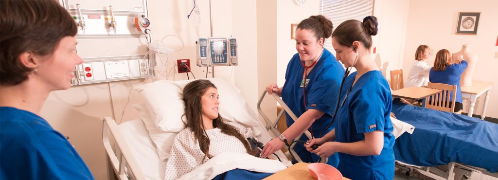 Vermont Tech Nursing students attend to a patient in lab