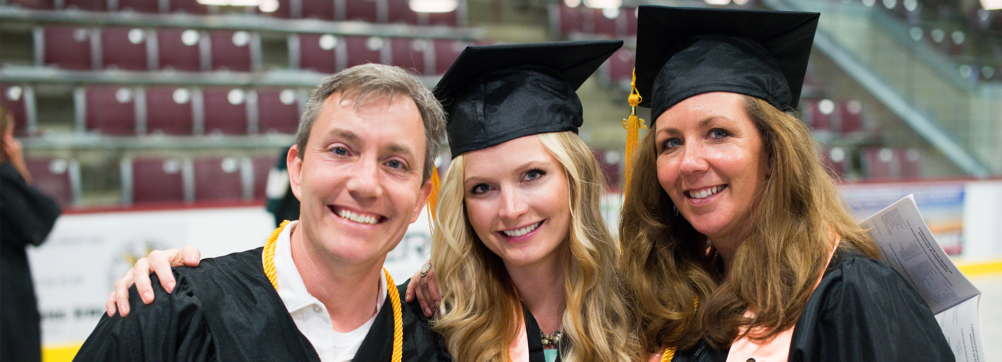 Students smiling at commencement, graduation