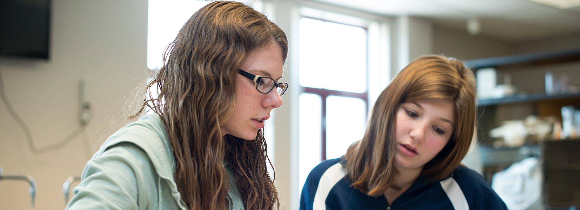 Female students work together in a science lab