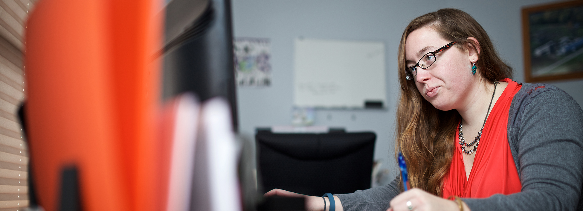 Girl looks at a computer screen while working.