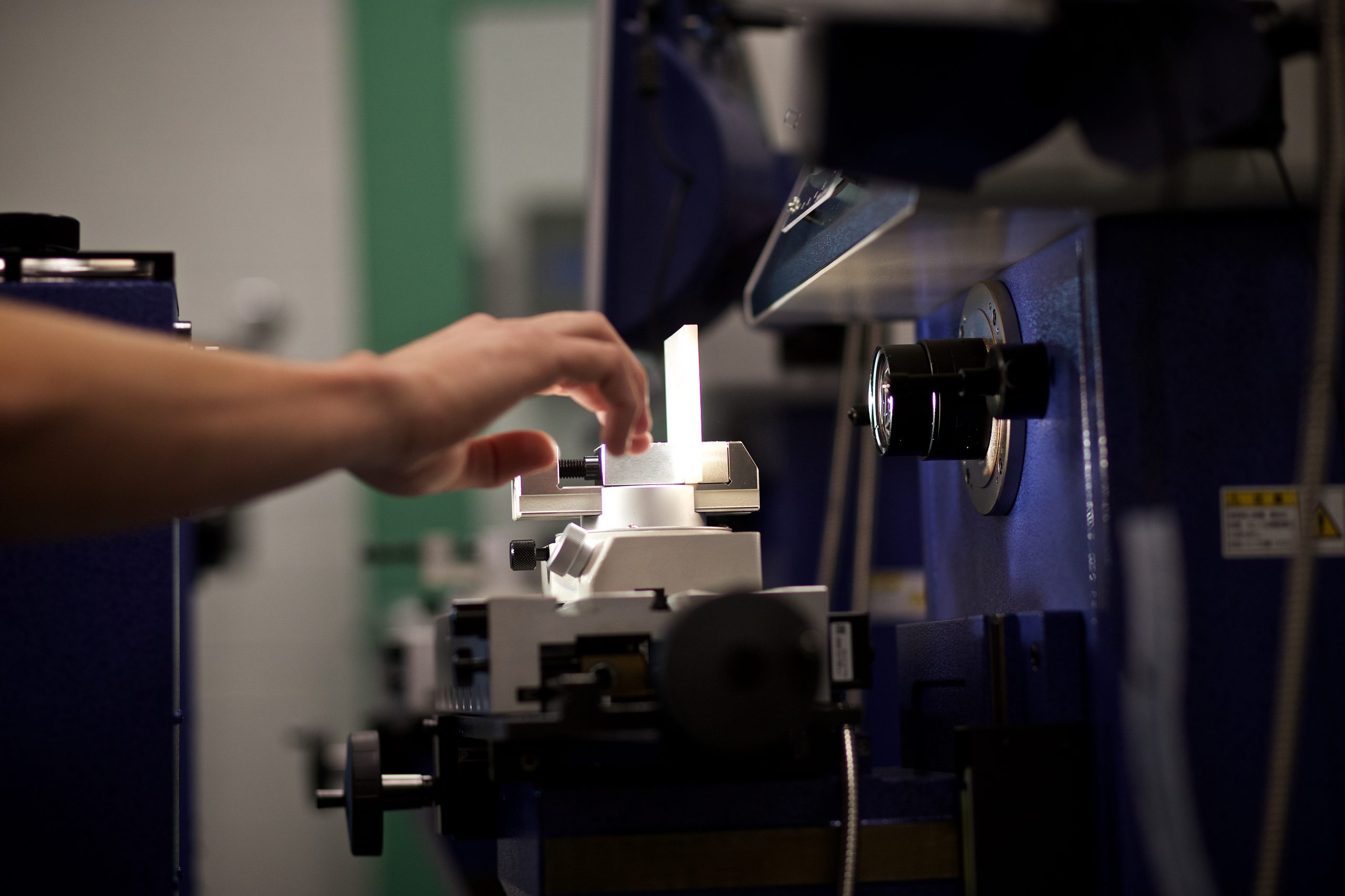 Vermont Tech students measures a manufacturing production piece in the metrology lab