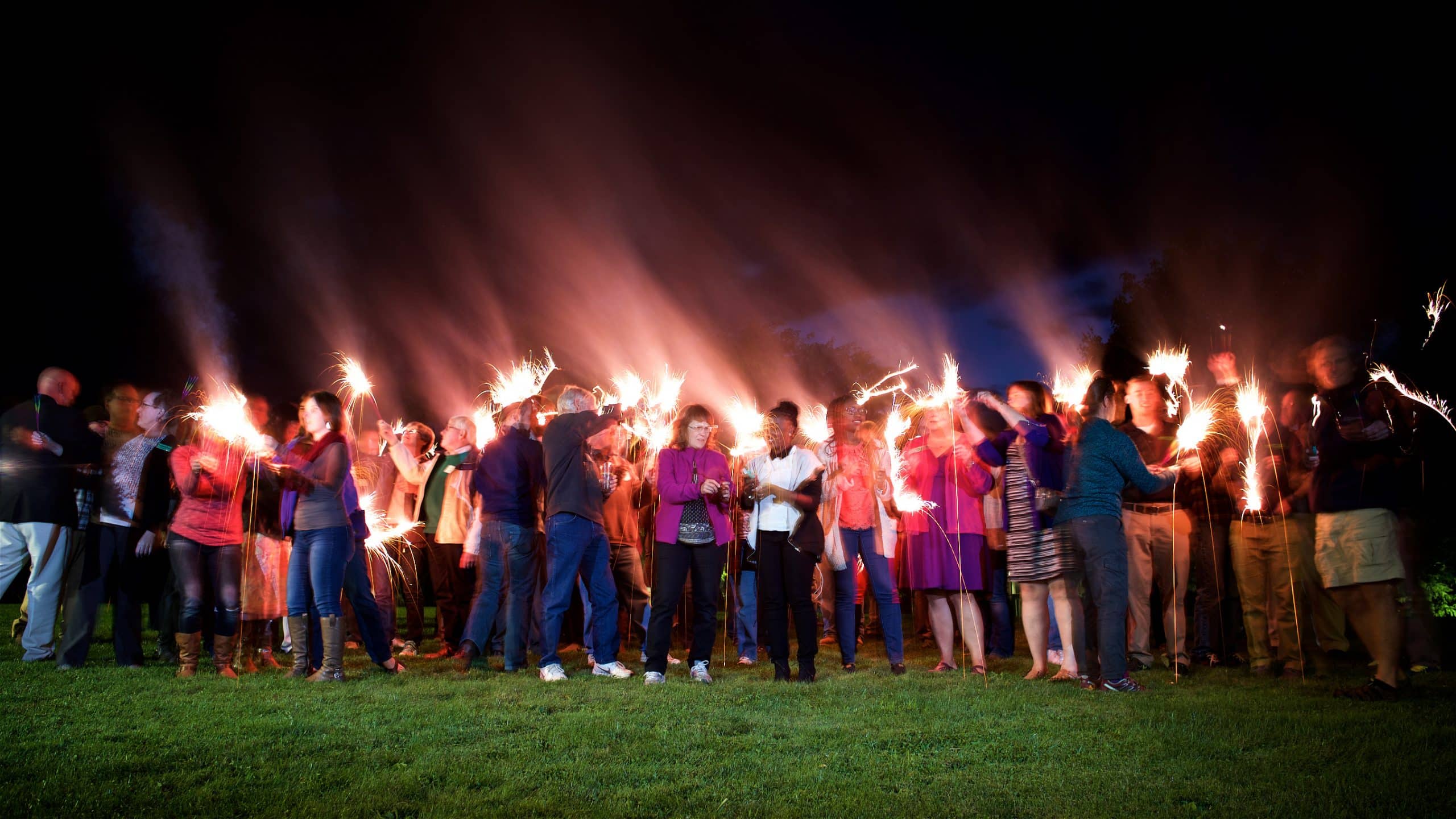 Group photo of everyone with their sparklers during the evening portion of the event.