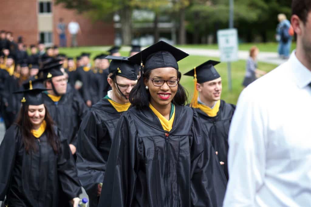 A smiling student about to graduate.