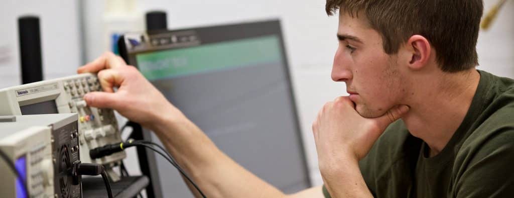 An student working on an electrical engineering project.