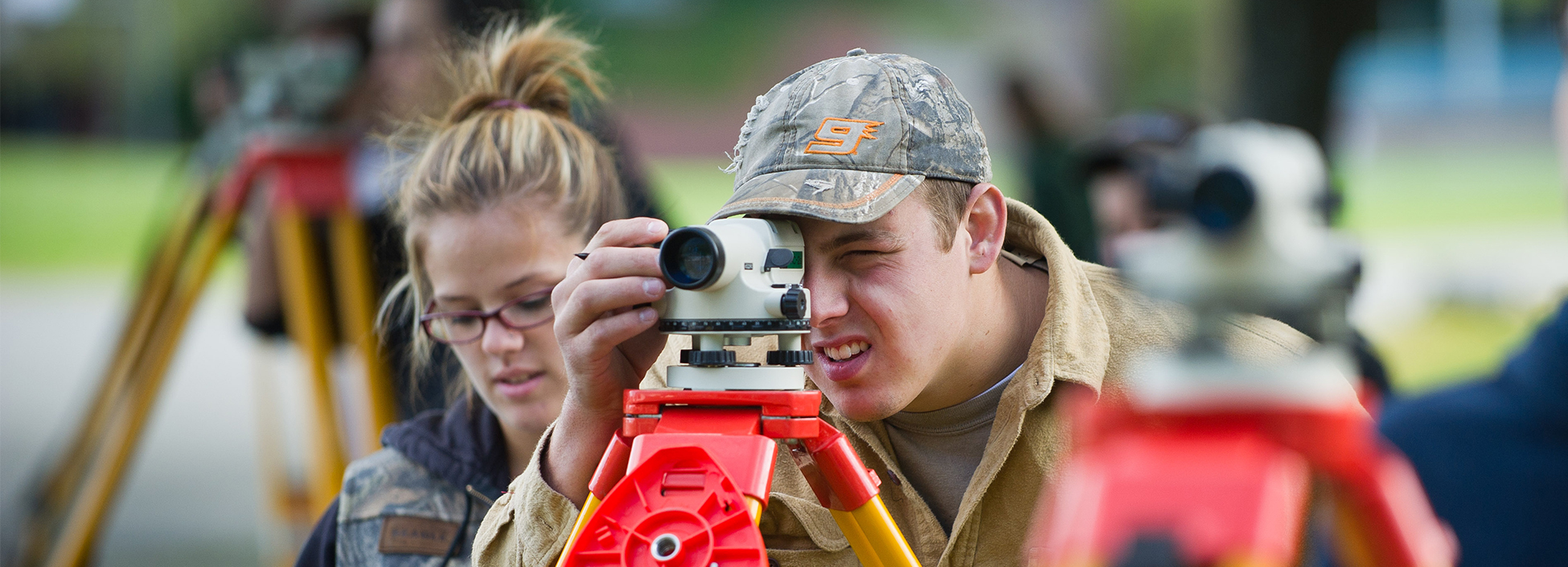 Students work outside learning how to survey land on the Randolph Center campus, civil engineering