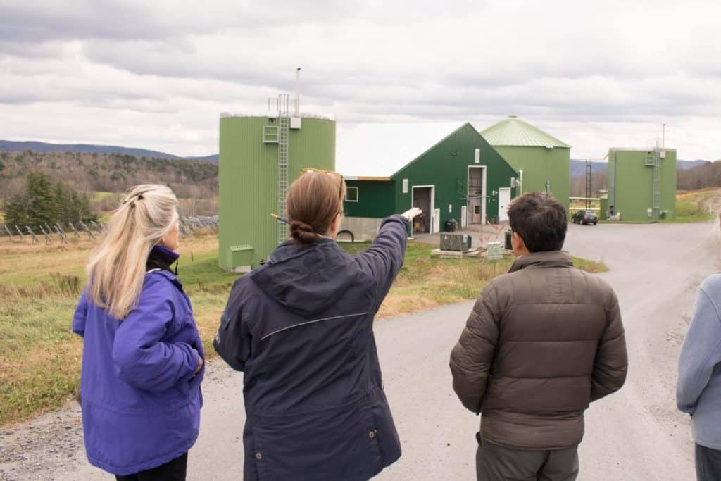 The group observes the biodigester from afar, Randolph Center campus