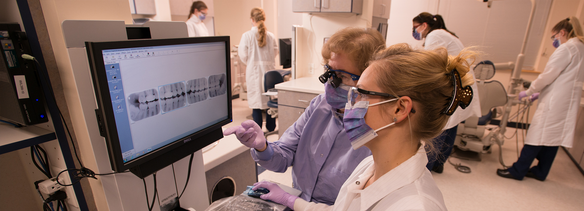 Dental Hygiene student and faculty examine x-rays at the Williston campus.