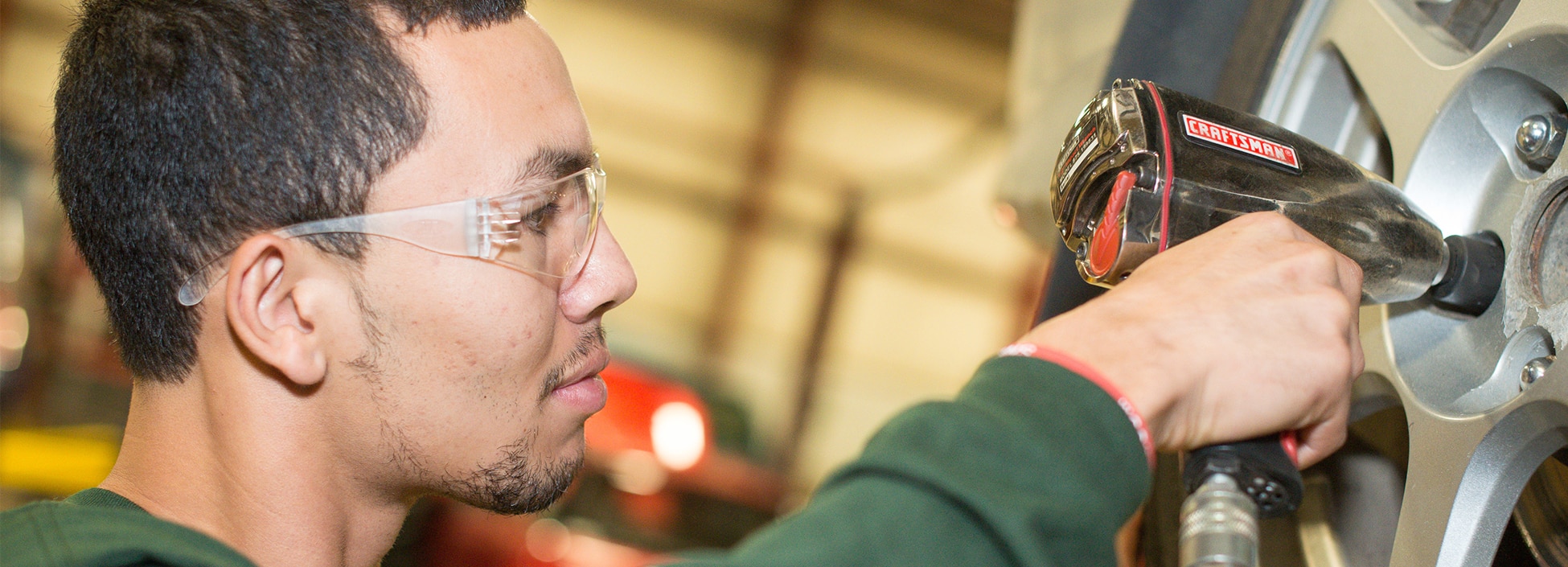 a student changes the tire of a large diesel vehicle, laboratory, diversity, hands on