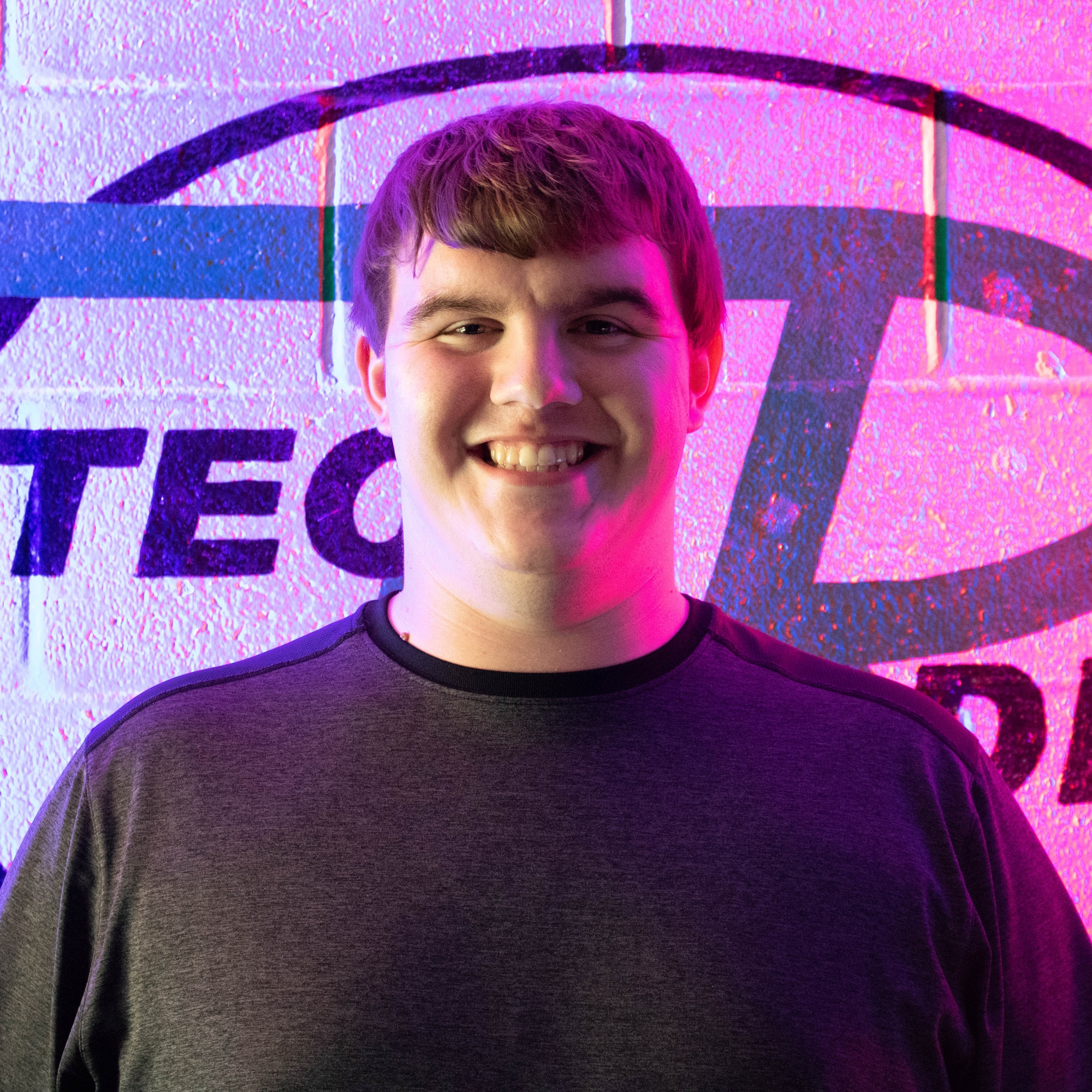 Zach Davis, student, in front of the WVTC sign on the wall