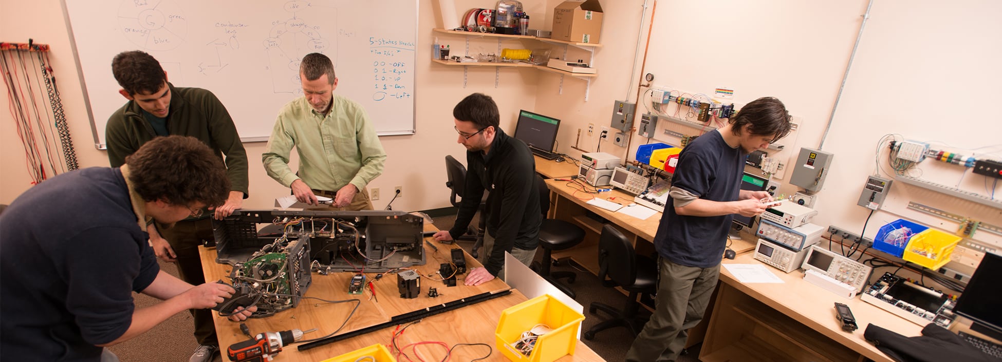 Students take apart a computer in the Computer Software Engineering lab, hands on