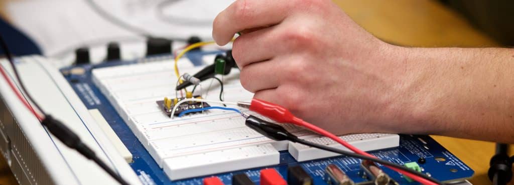 a student wires his final project, electrical engineering, hands sodering