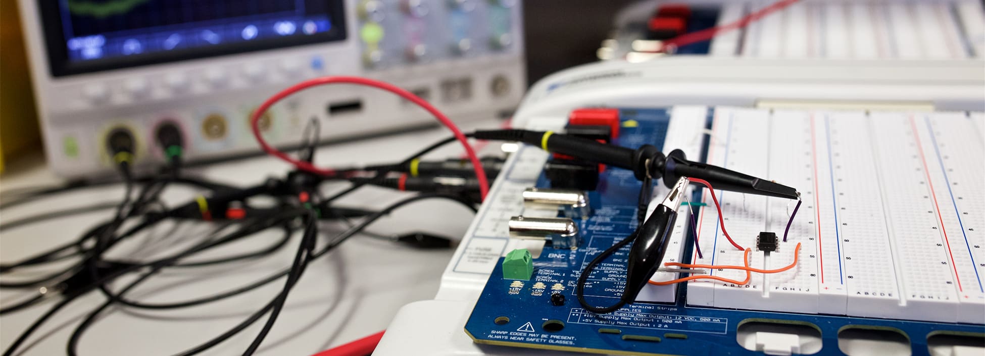 electrical equipment laid out on a workbench, engineering