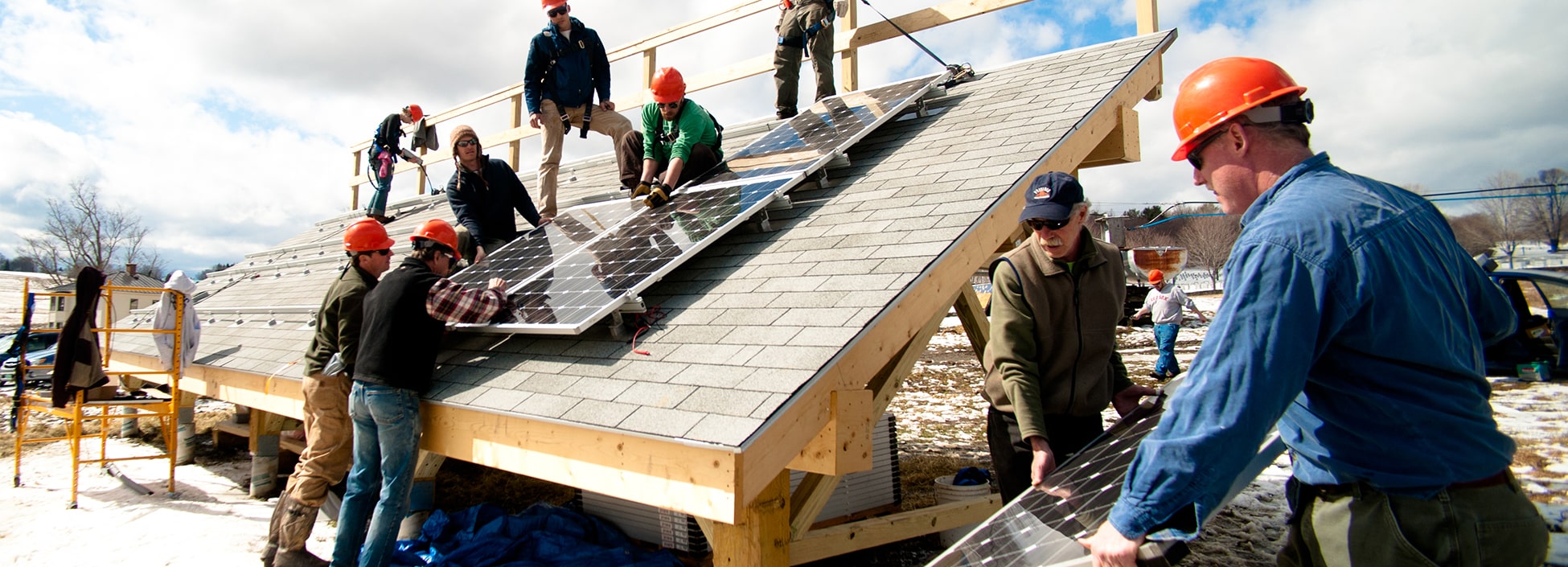 Students of the Renewable Energy program install solar panels at the Langevin house on the Randolph Center Campus, lab,  hands on