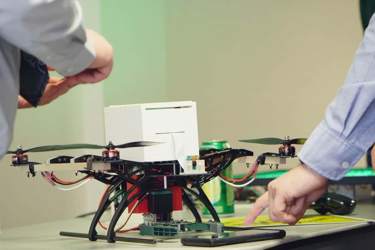 Logan, student uses an android phone to control the claw attachment of the drone, senior project