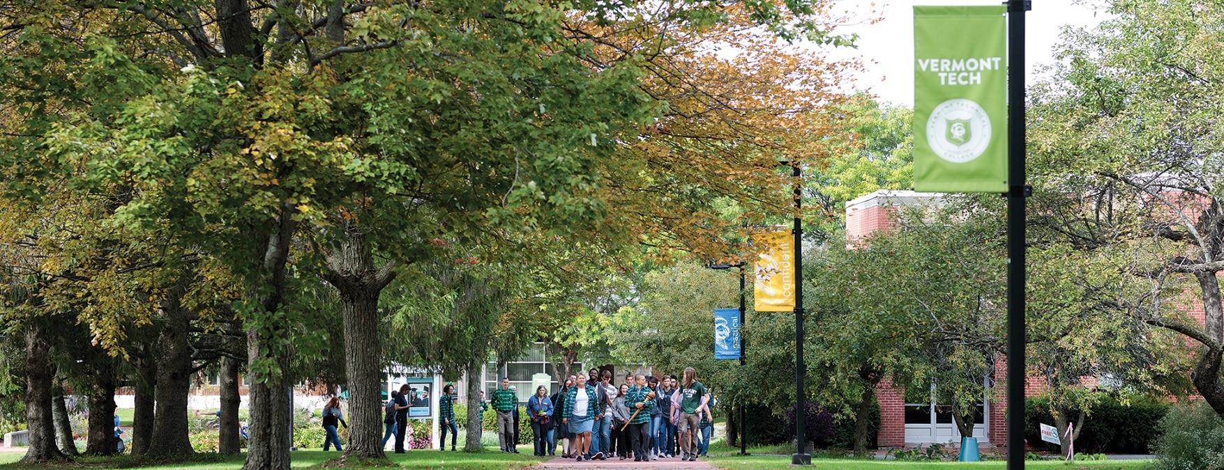 Students, faculty, and staff march up walkway, Randolph Center campus