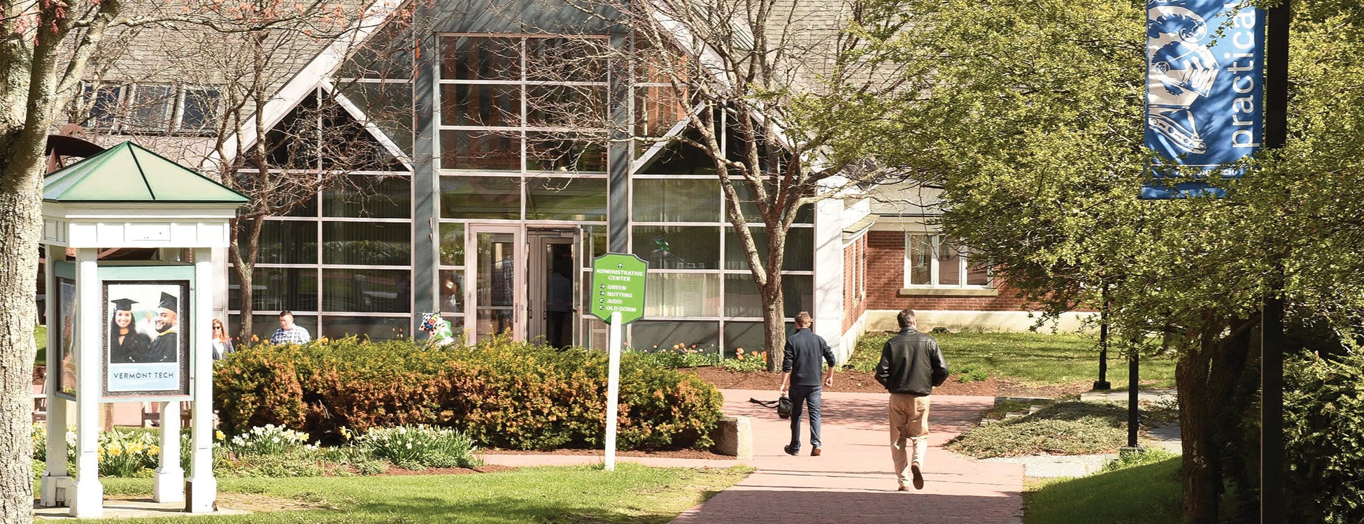 Students walk toward Administrative Building on Randolph Center campus