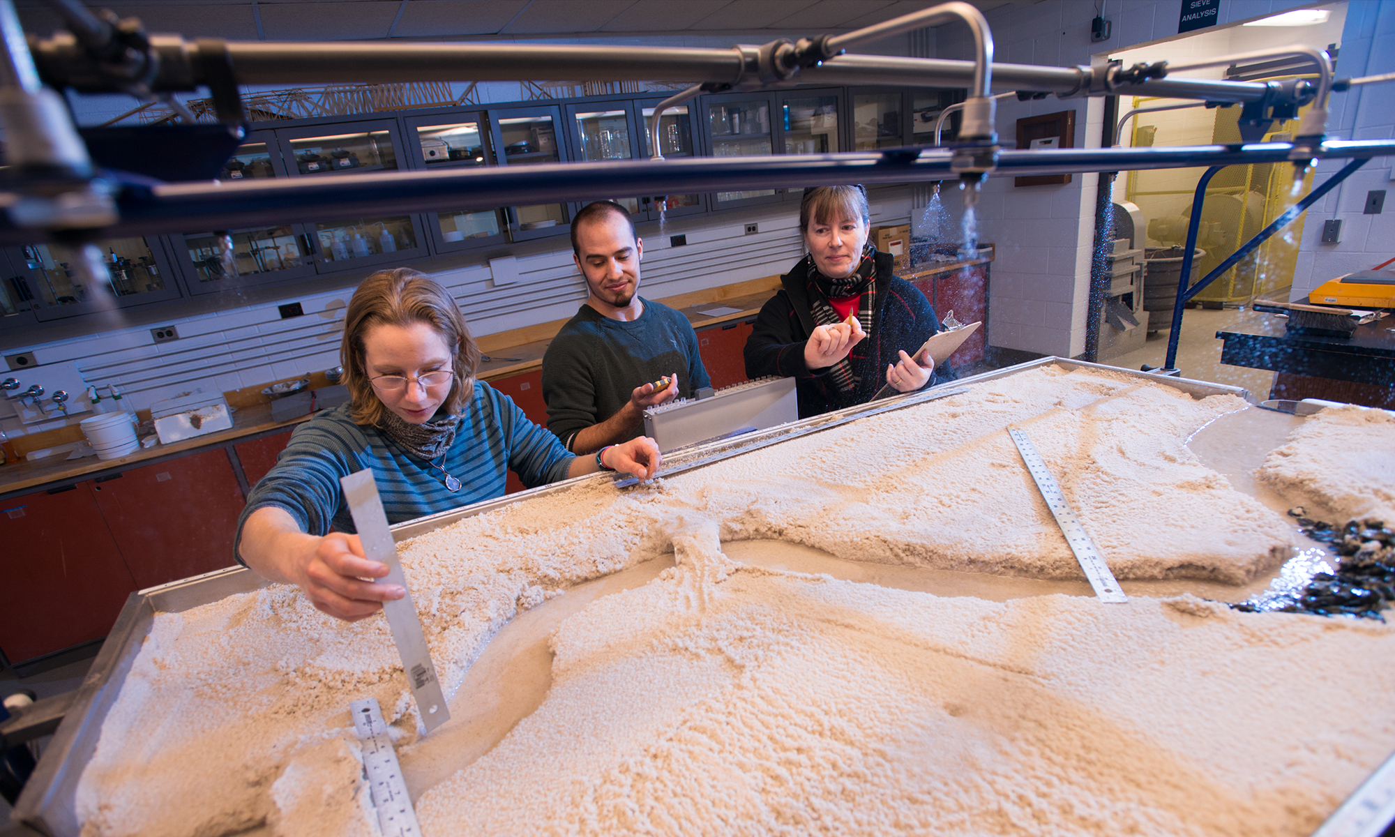 Students work in the civil lab on the water table, civil engineering, STEM, hands on