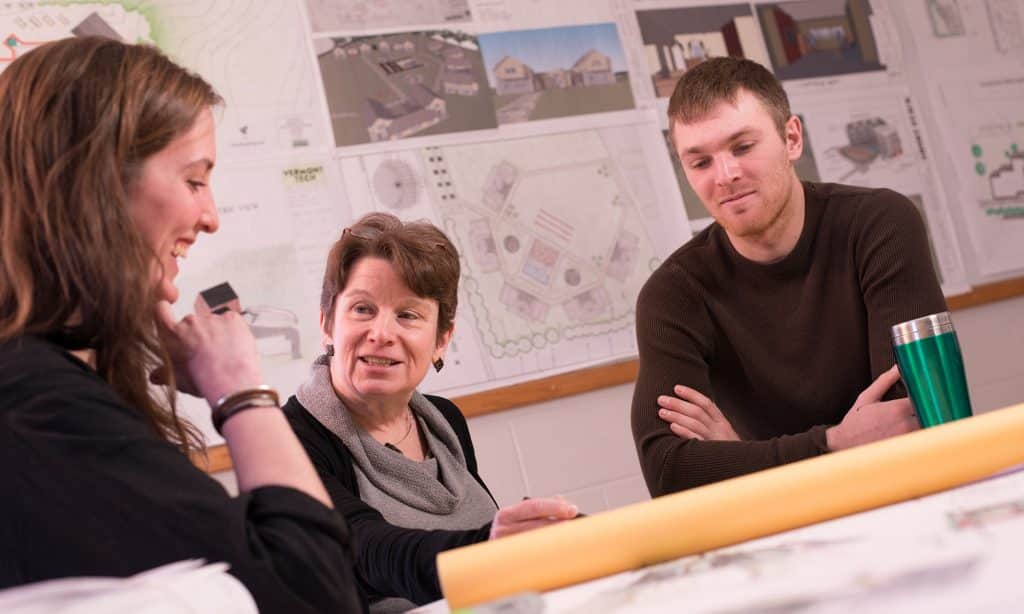 Architecture students review their blueprints with an architecture professor, architectural engineering, STEM, hands on