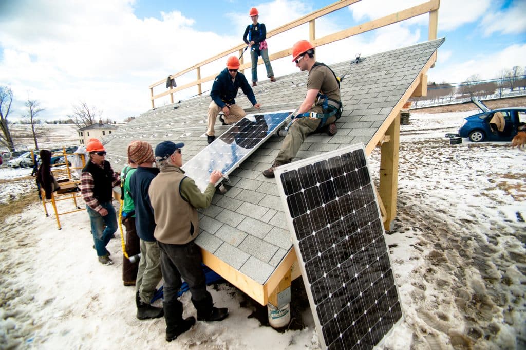 Students learning how to install a solar panel, Randolph Center campus