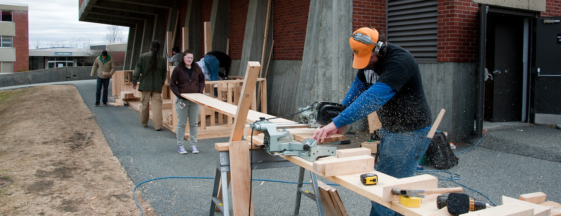 Students outside working, power saws