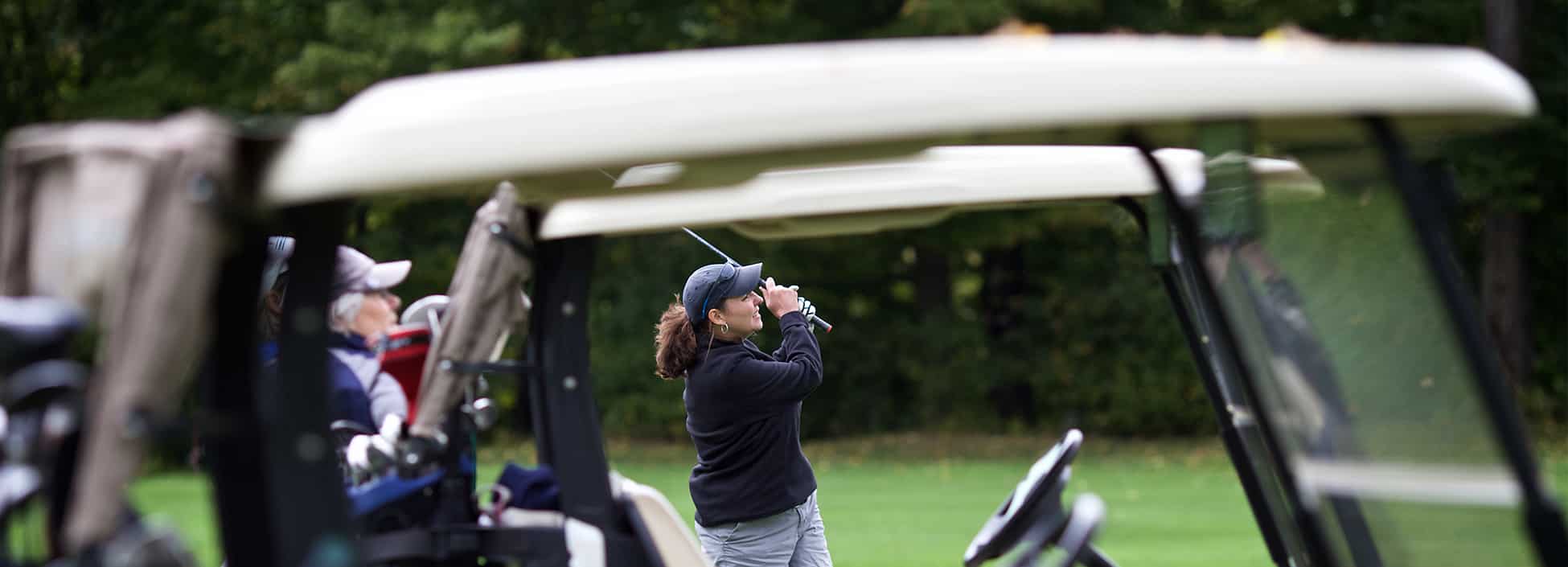 female golfer, swing, golf cart