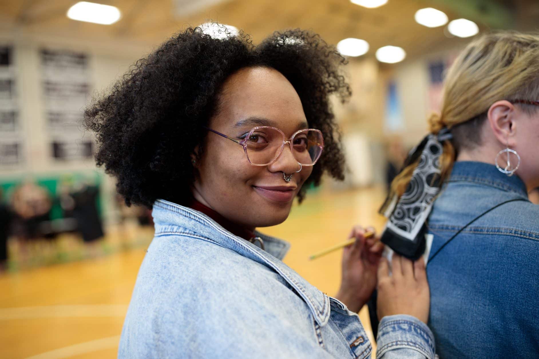 female student, smiling, writing, diversity