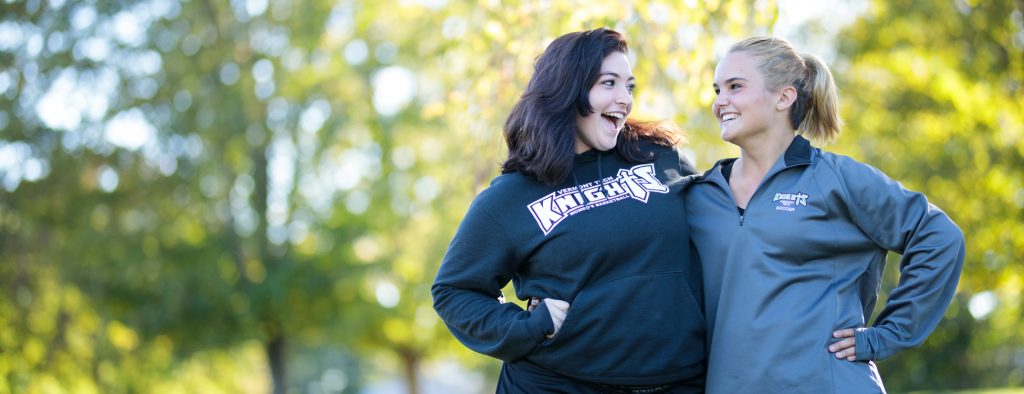 Female students, smiling at each other, goofy, cute