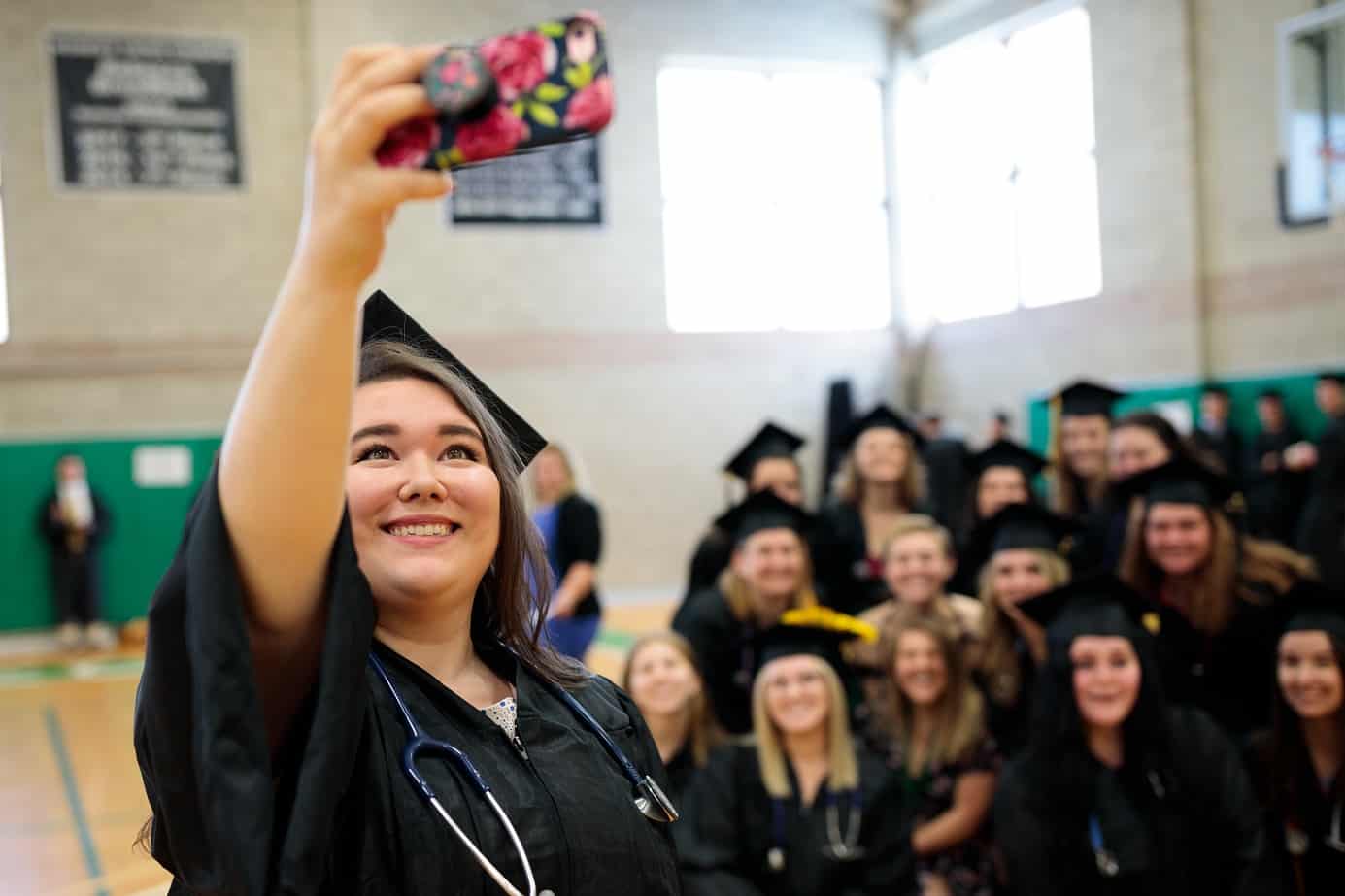 Nursing students, female, posing for group selfie, commencement, graduation