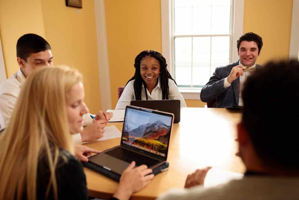 Female students, male students, conference room, business technology and management, laptops, notes