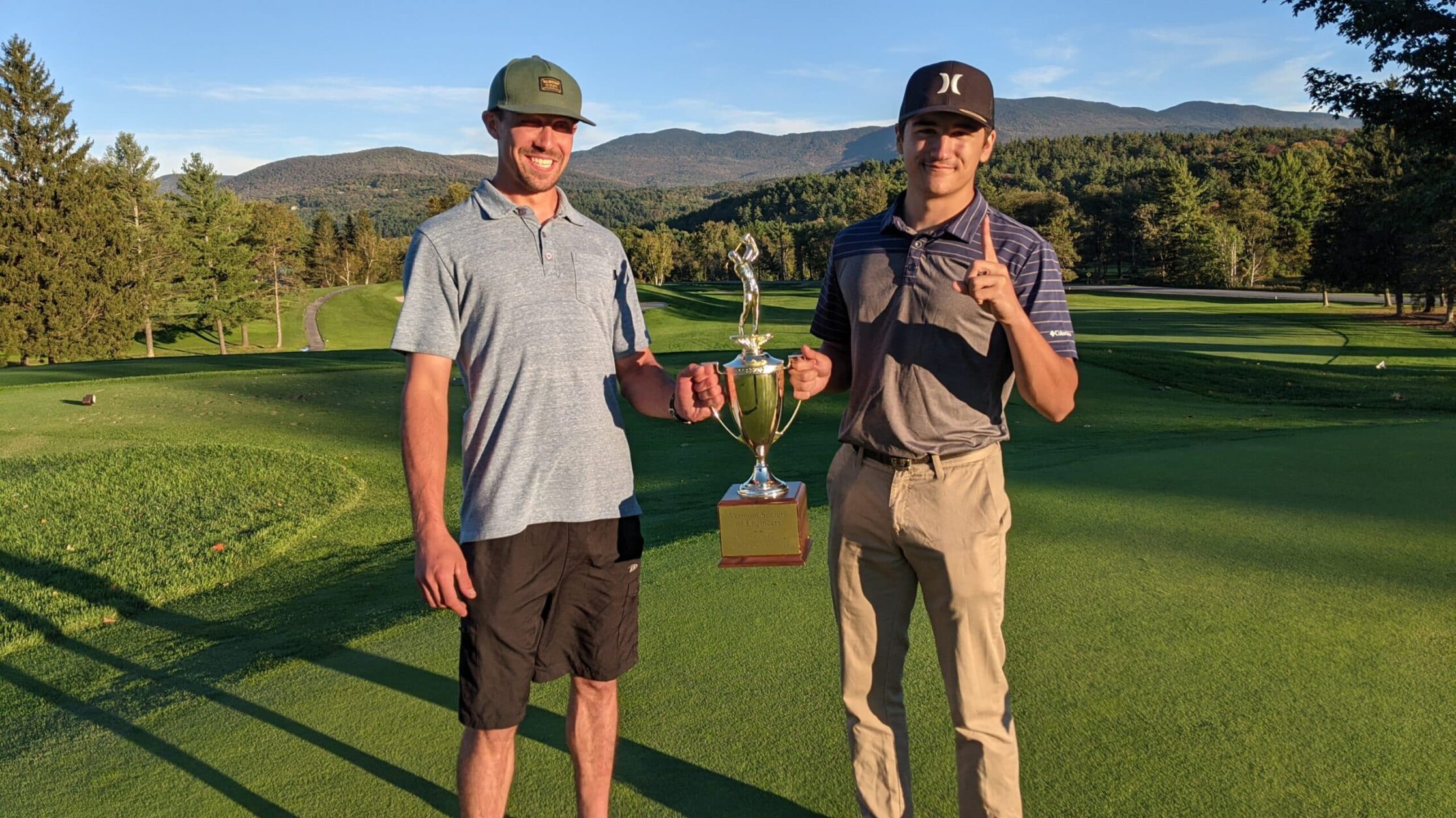 Golf tournament winners hold the trophy